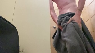 In the public showers of a campground with an erection and a little pee