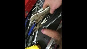 Mechanic Plays with his Tools