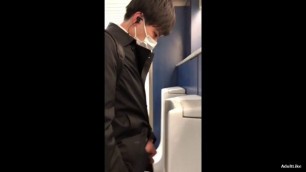 A male is pissing in the toilet 2.